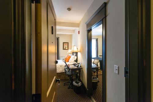 a hallway of a hotel room with a desk and a mirror at Camas Boutique Hotel in Camas