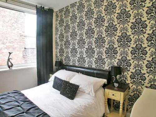 A bed or beds in a room at The Beach Hut 