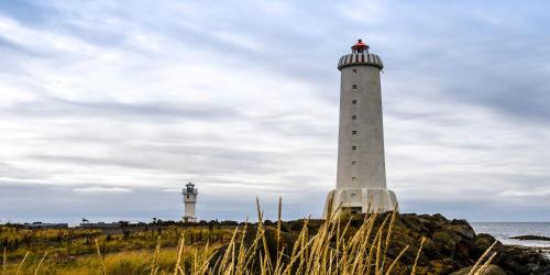 two lighthouses on the shore of the ocean at Móar Cottage in Akranes