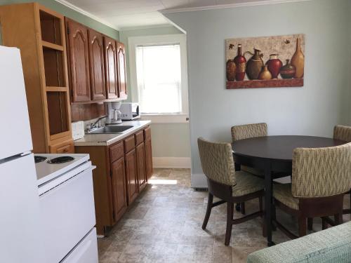 een keuken met een tafel en stoelen in een kamer bij Mallard Apartments in Ocean City