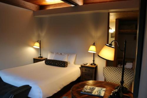 A bed or beds in a room at Timbers Inn