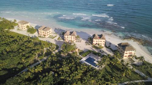 an aerial view of a resort on the beach at Caleta Tankah in Tulum