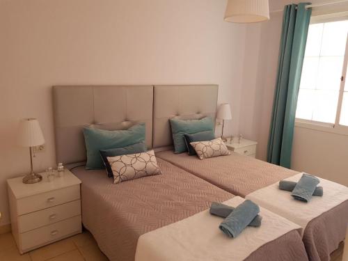 コスタ・カルマにあるCosta Paradiseのベッドルーム1室(青い枕付きのベッド2台付)