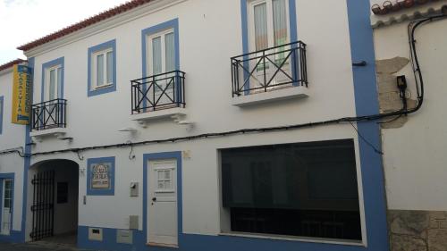 a building with blue and white paint on it at Travelers by Rio NaturAL in Vila Nova de Milfontes