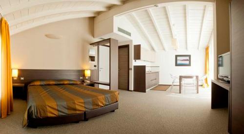 a large bedroom with a bed and a kitchen at Locanda Sant'Ambrogio in Rivalta
