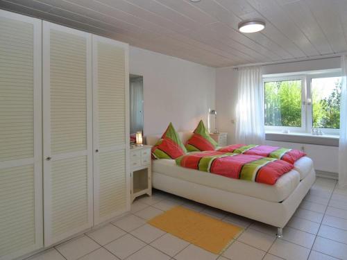 a bedroom with a bed and a window at Relax in Homberg