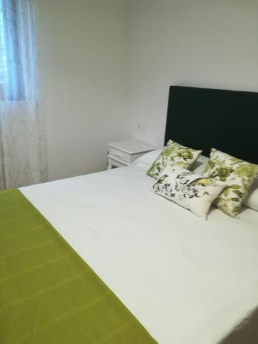 a white bed with two pillows on top of it at Pico San Carlos ll in Bejes