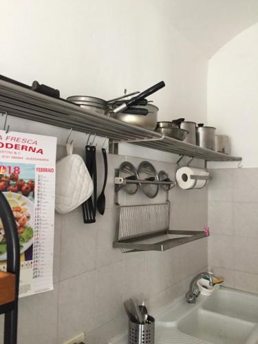 a kitchen with pots and pans and a sink at Appartamento A.D. in Alessandria