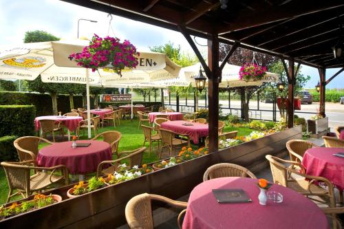 a restaurant with purple tables and chairs and flowers at Hotel Restaurant in den Hoof in Maastricht