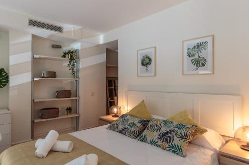 a bedroom with a large bed with pillows at Modern and Trendy Duplex next to Paseo de Gracia in Barcelona
