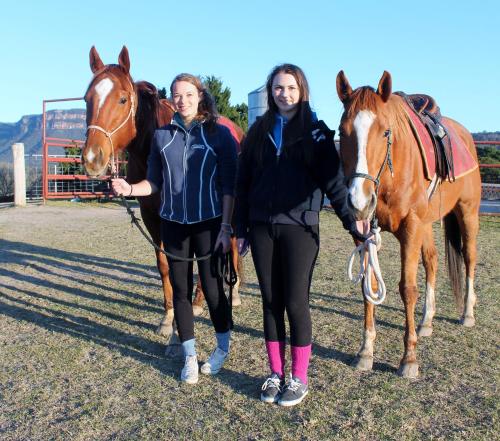 two women are standing next to two horses at Mountain Whispers Varenna Luxury in Leura