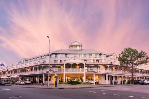 a large white building on the corner of a street at Esplanade Hotel Fremantle - by Rydges in Fremantle