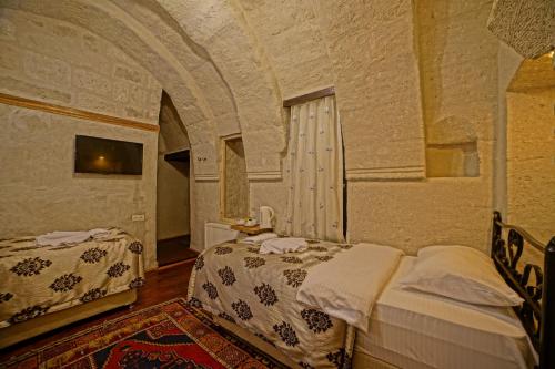 Katil atau katil-katil dalam bilik di Melek Cave Hotel