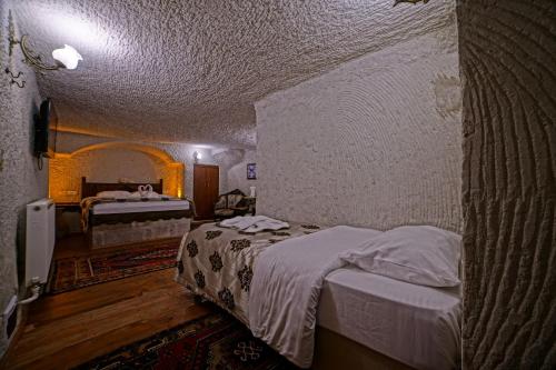 Katil atau katil-katil dalam bilik di Melek Cave Hotel