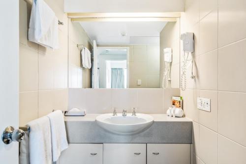 a bathroom with a sink and a mirror at Dockside Brisbane in Brisbane