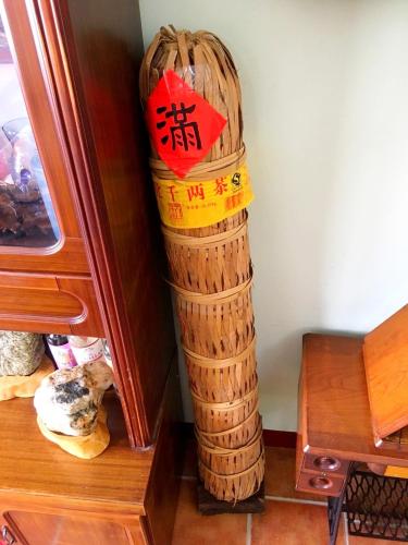 a basket with writing on it sitting next to a table at Jiang Shui Village B&B in Fenglin