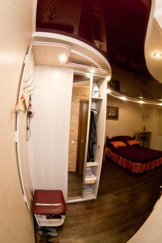 a room with a mirror and a room with a bed at затишна квартирка in Kremenchuk