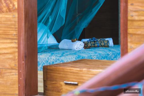 a reflection of a bed in a mirror at Tevana House Reef in Bira