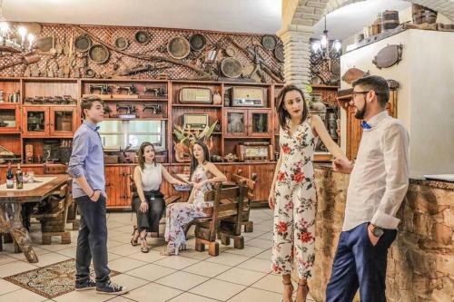 a group of people standing in a room at Hotel Villaggio Ristorante Pizzeria Museo TANIT in Carbonia