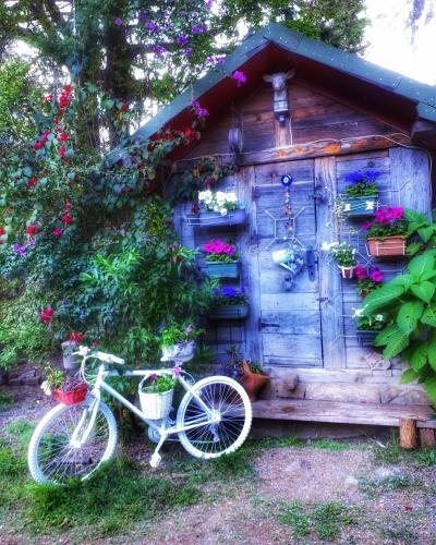 a bike parked in front of a house with flowers at Portalimo Lodge Hotel - Adult Only +12 in Cıralı