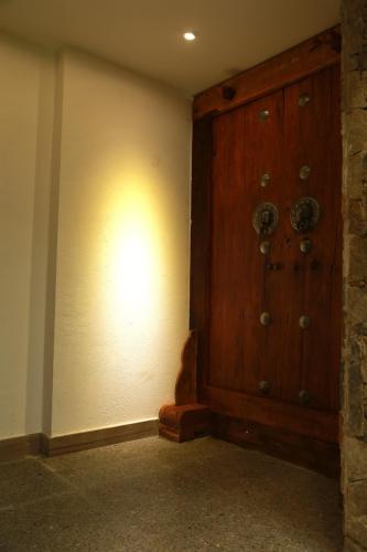 a large wooden door in a room with a wall at Beyond the Terrace Residence in Yuanyang
