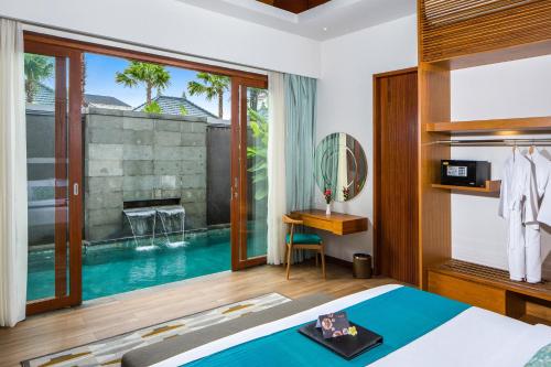 a bedroom with a swimming pool next to a bed at S18 Bali Villas in Legian
