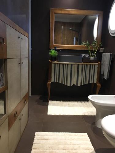 a bathroom with a sink and a toilet at Oporto Beach in Gulpilhares