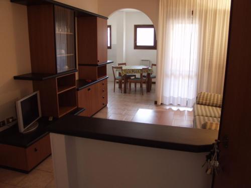 
a kitchen with a dining room table and chairs at RTA Le Corti in Grosseto
