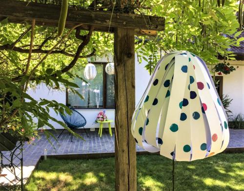 a polka dot umbrella sitting in a garden at Garden House in Timişoara