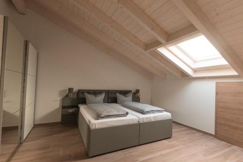 a bedroom with a bed and a skylight at Stadthotel Donauwörth in Donauwörth
