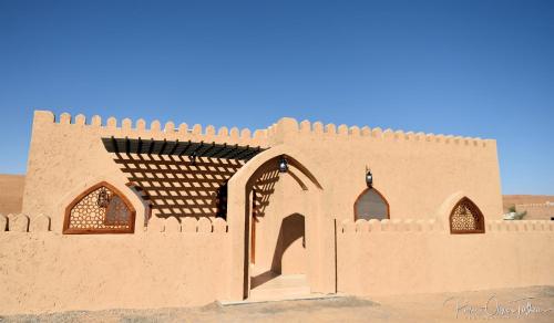 a model of a building in the desert at Arabian Oryx Camp in Shāhiq