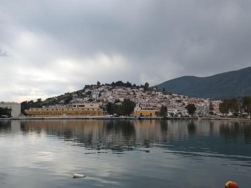 a town on a hill next to a body of water at Christina Perlia Studios in Poros