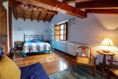 a bedroom with a bed in a room with wooden ceilings at Apartamentos Casa Placida 1 in Frama