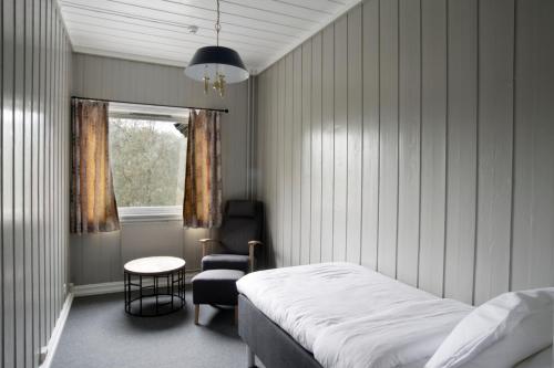 A bed or beds in a room at Morgedal Hotel - Unike Hoteller
