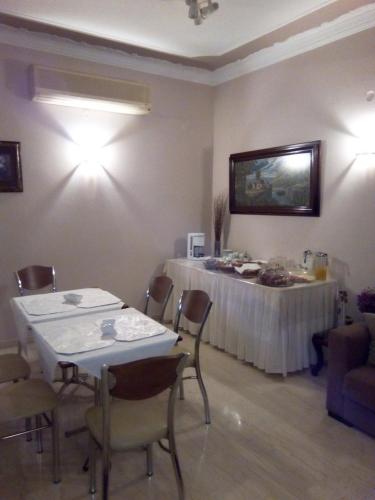 a room with a table and chairs and a tv on the wall at Ermis in Loutra Ipatis