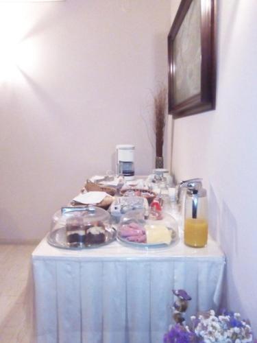 a table with a blue table cloth with food on it at Ermis in Loutra Ipatis