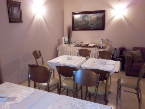 a dining room with tables and chairs in a room at Ermis in Loutra Ipatis