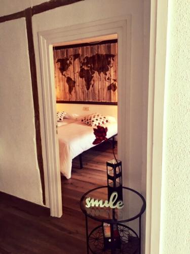 a bedroom with a bed and a table and a chair at Pension Casa Pinilla in Cascante