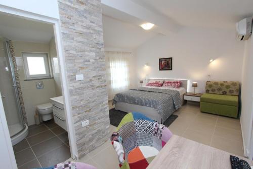 a small bedroom with a bed and a bathroom at Apartments Sorriso in Rovinj