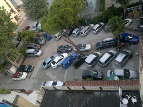 an aerial view of a bunch of cars parked in a parking lot at Hotel AMALFI in Lido di Jesolo