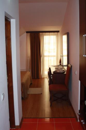 a room with a desk and a bed and a window at Lacul Racilor in Olimp