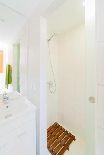 a white bathroom with a shower and a sink at Aguda Beach Charming House By PortoProperties4You in Vila Nova de Gaia