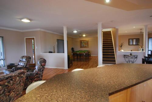 a kitchen and living room with a table and chairs at Mountain Park Retreat in Perth