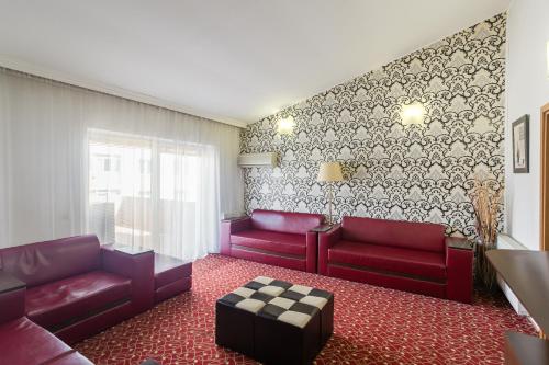 a living room with red couches and a couch at Casa Sofia in Bucharest