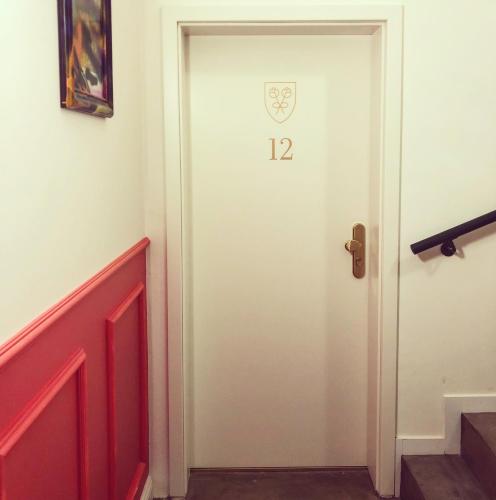 a white door with the number on it at Victoria Hotel in Düsseldorf