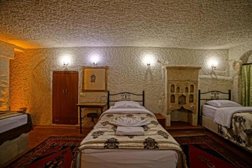 Katil atau katil-katil dalam bilik di Melek Cave Hotel