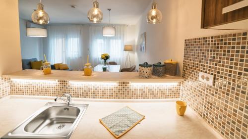 a kitchen with a sink and a counter at Novel Inn in Belgrade