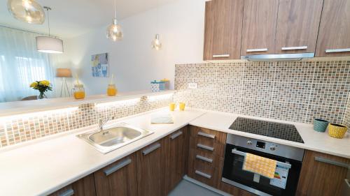 a kitchen with a sink and a stove at Novel Inn in Belgrade