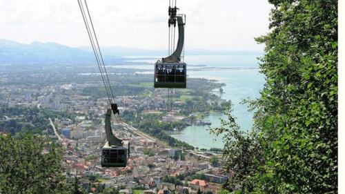two gondolas in the air over a city at F E R I E N W O H N U N G "Am Halbenstein" in Hörbranz