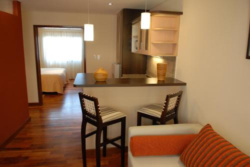 a living room with a couch and a table and chairs at Hotel Ankara Suites in Salta